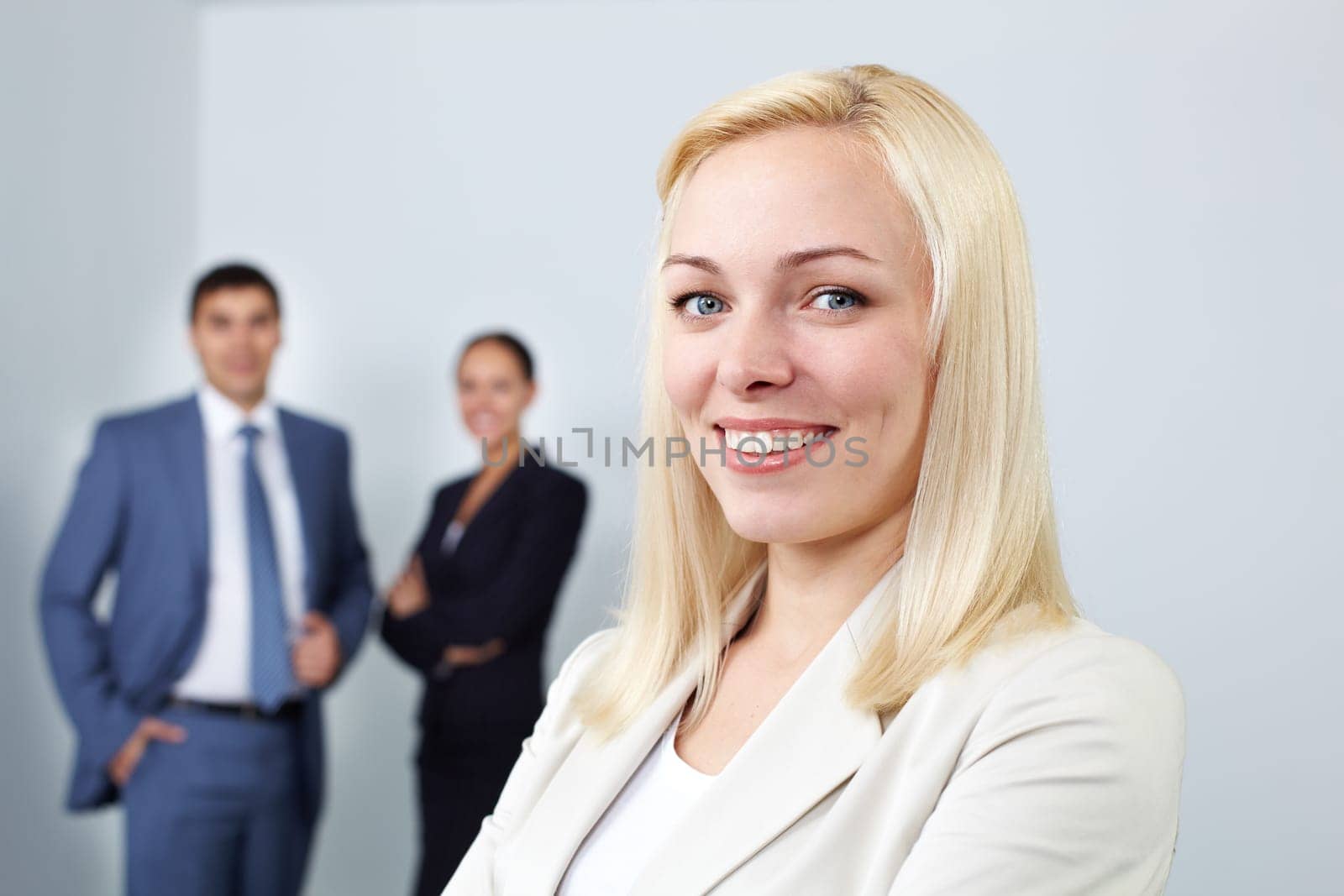 Portrait of a young woman looking at camera and smiling in office