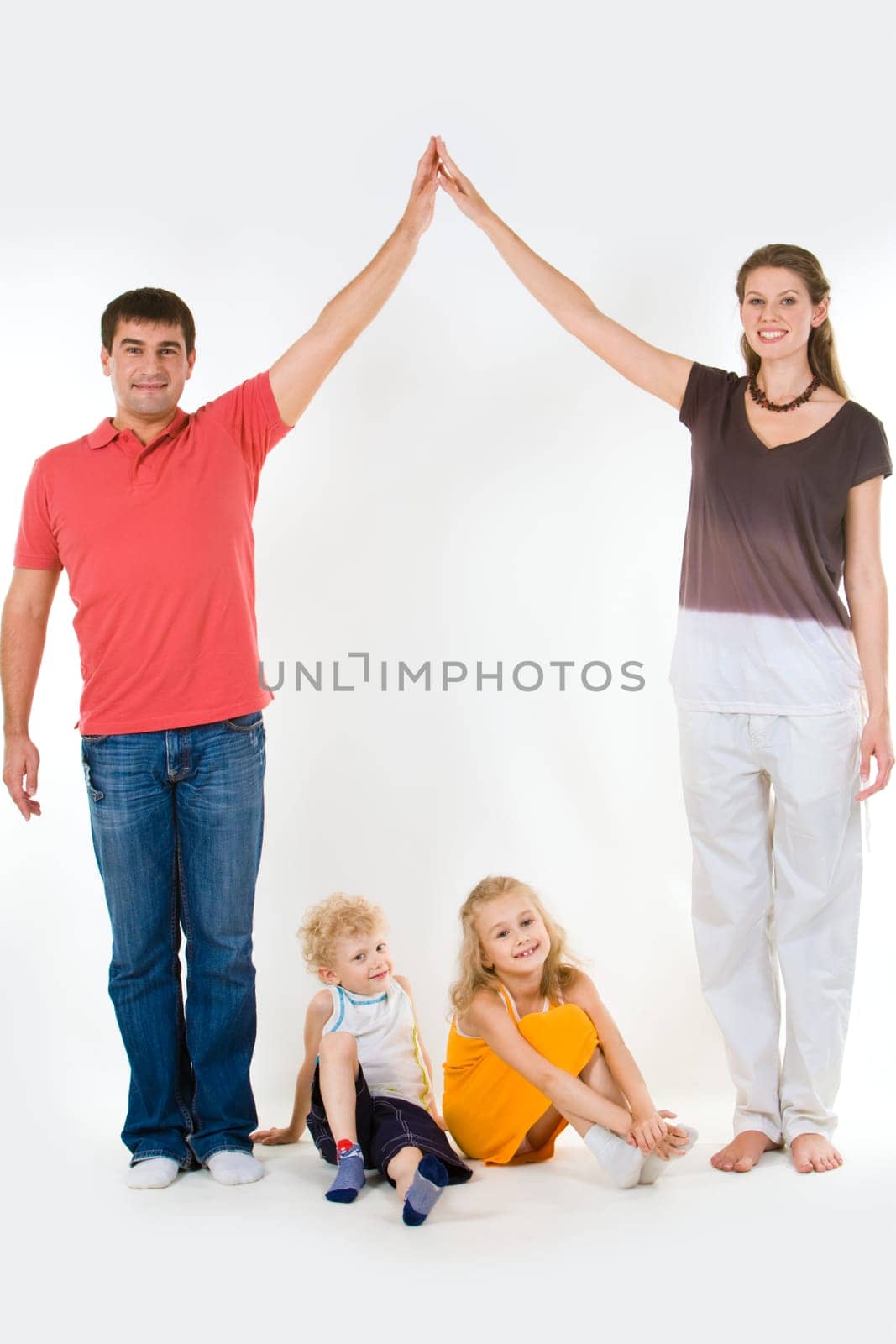 Image of husband and wife touching their hands over children