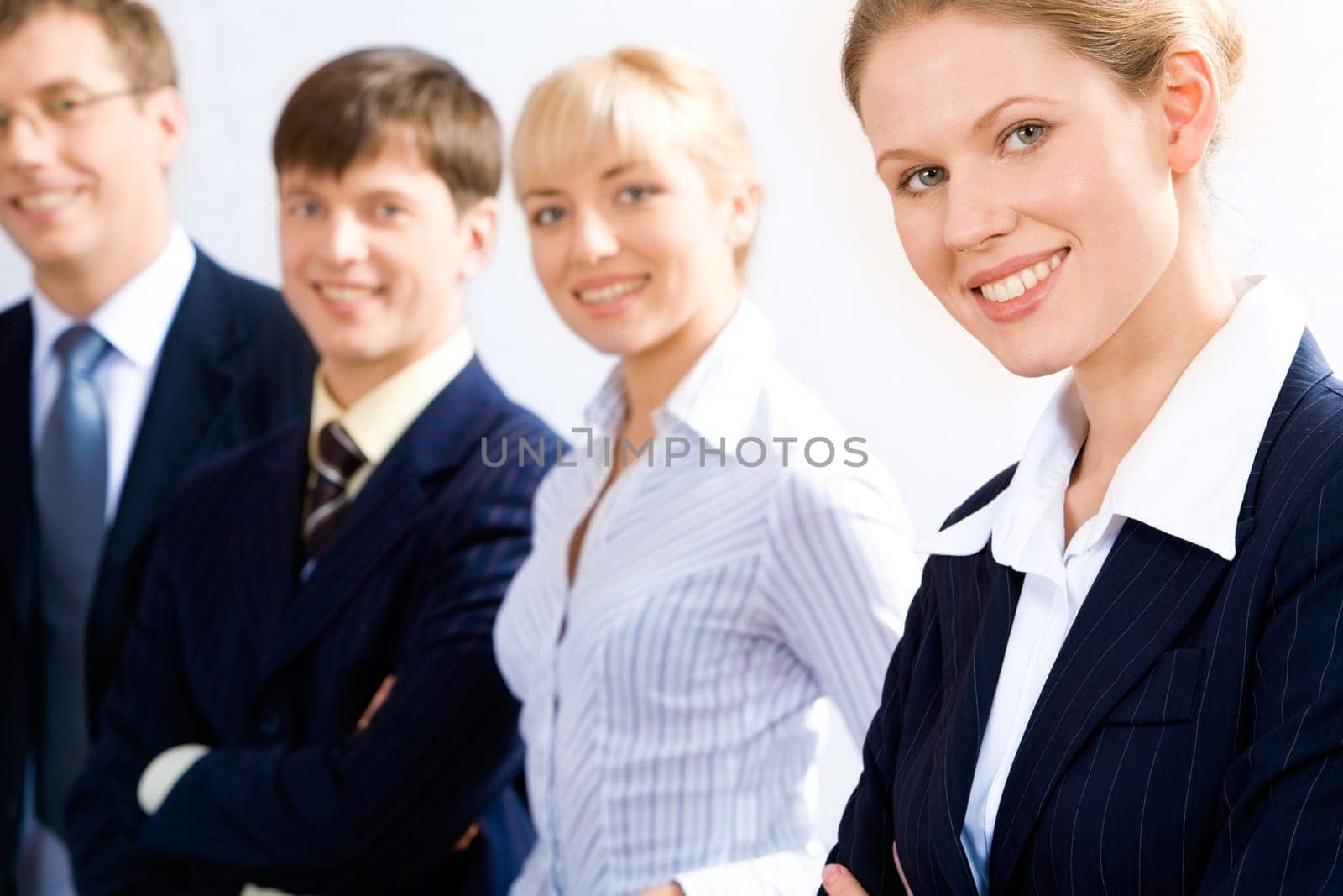 Portrait of business leader with her working team