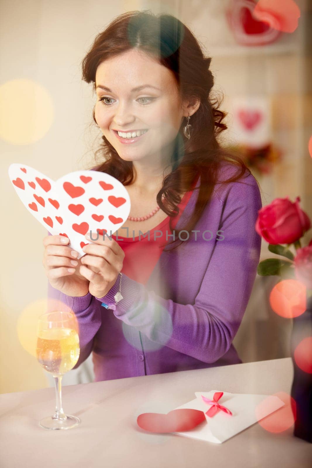 A young girl in restaurant holding Valentine card