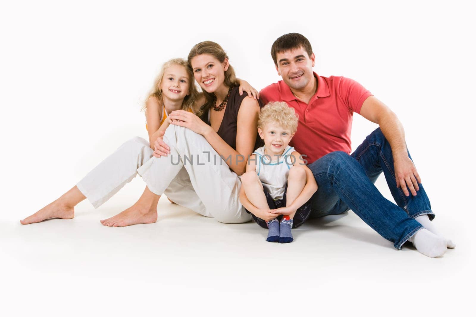 Portrait of four smiling people sitting together in the studio