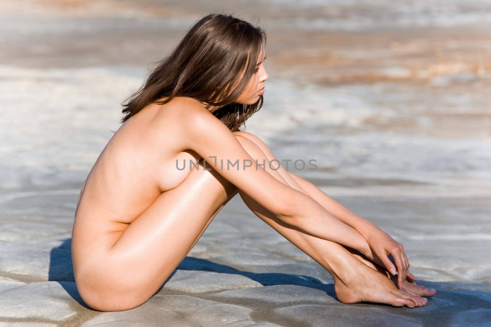 Portrait of nude woman sitting on the ground
