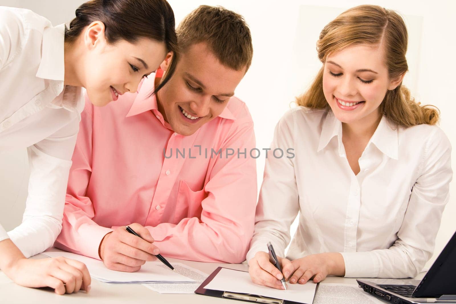 Portrait of business partners working together with papers in office