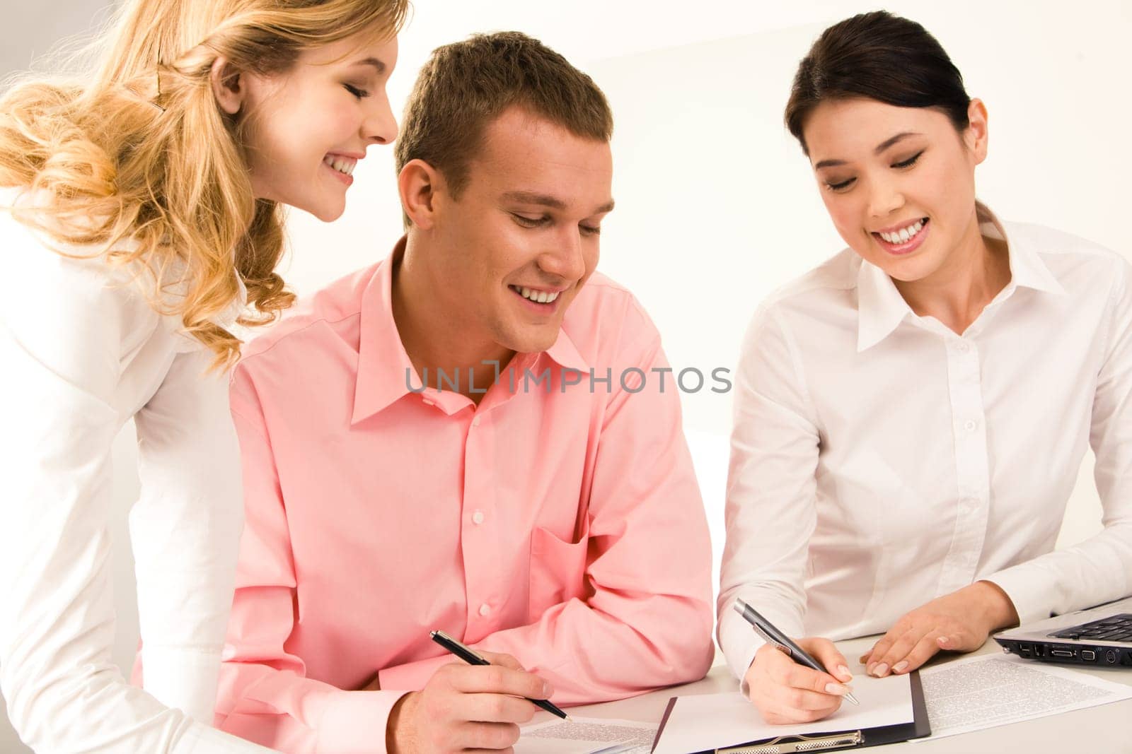Photo of successful business team working with papers while young female standing near by