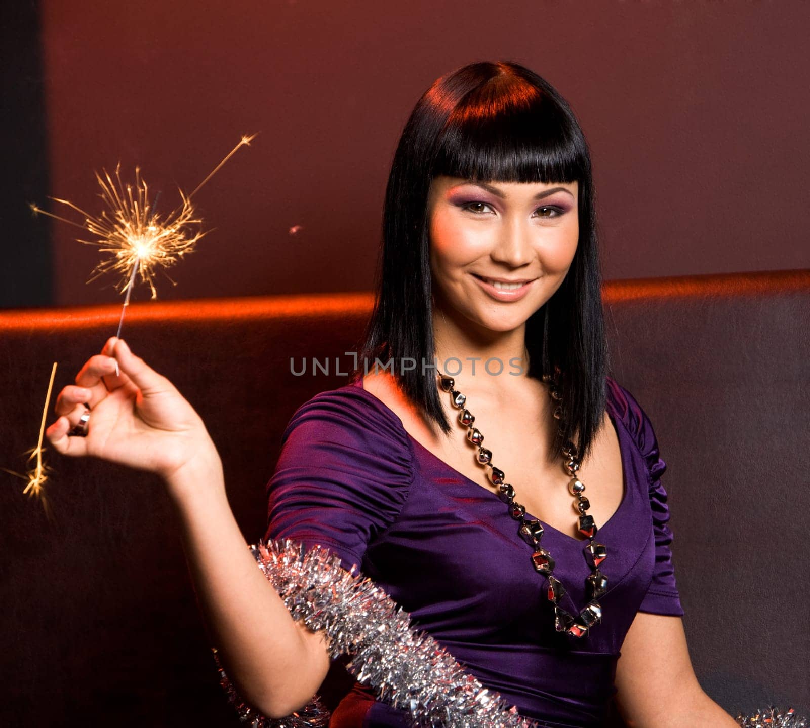 Portrait of smiling woman with Bengal light on Christmas night