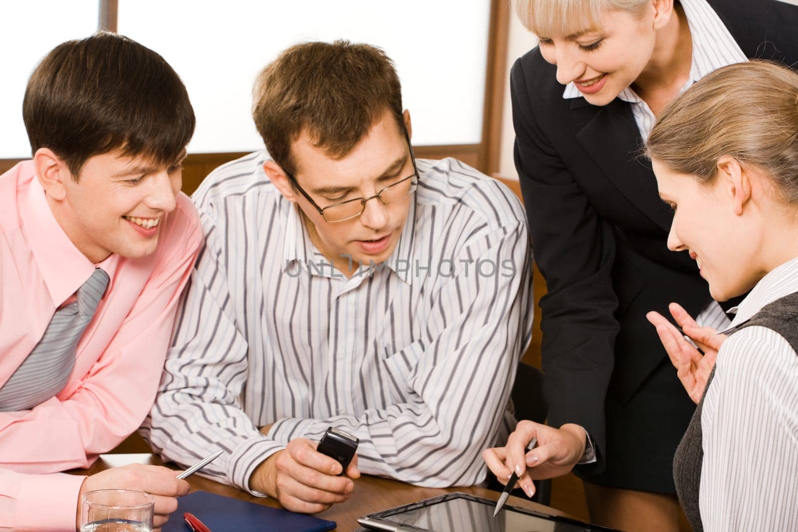 Business woman is explaining her business-plan to his colleagues pointing at laptop