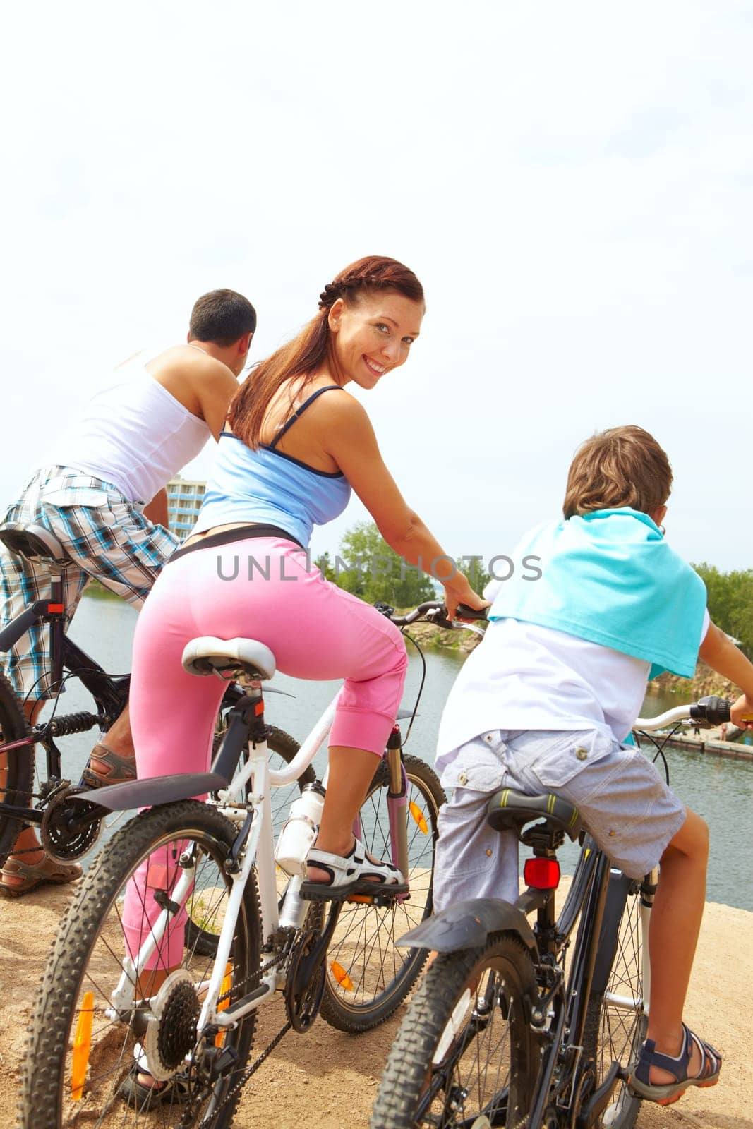 Rear view of family of three on bikes