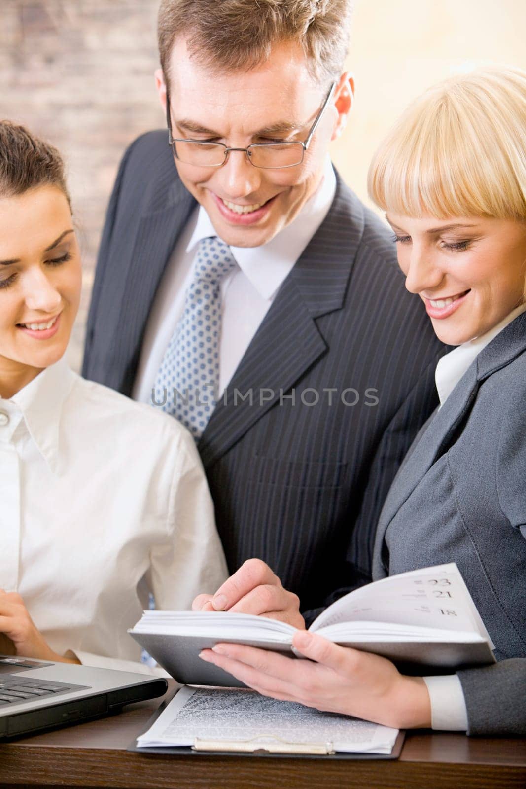 Portrait of three confident white collar office planning their work
