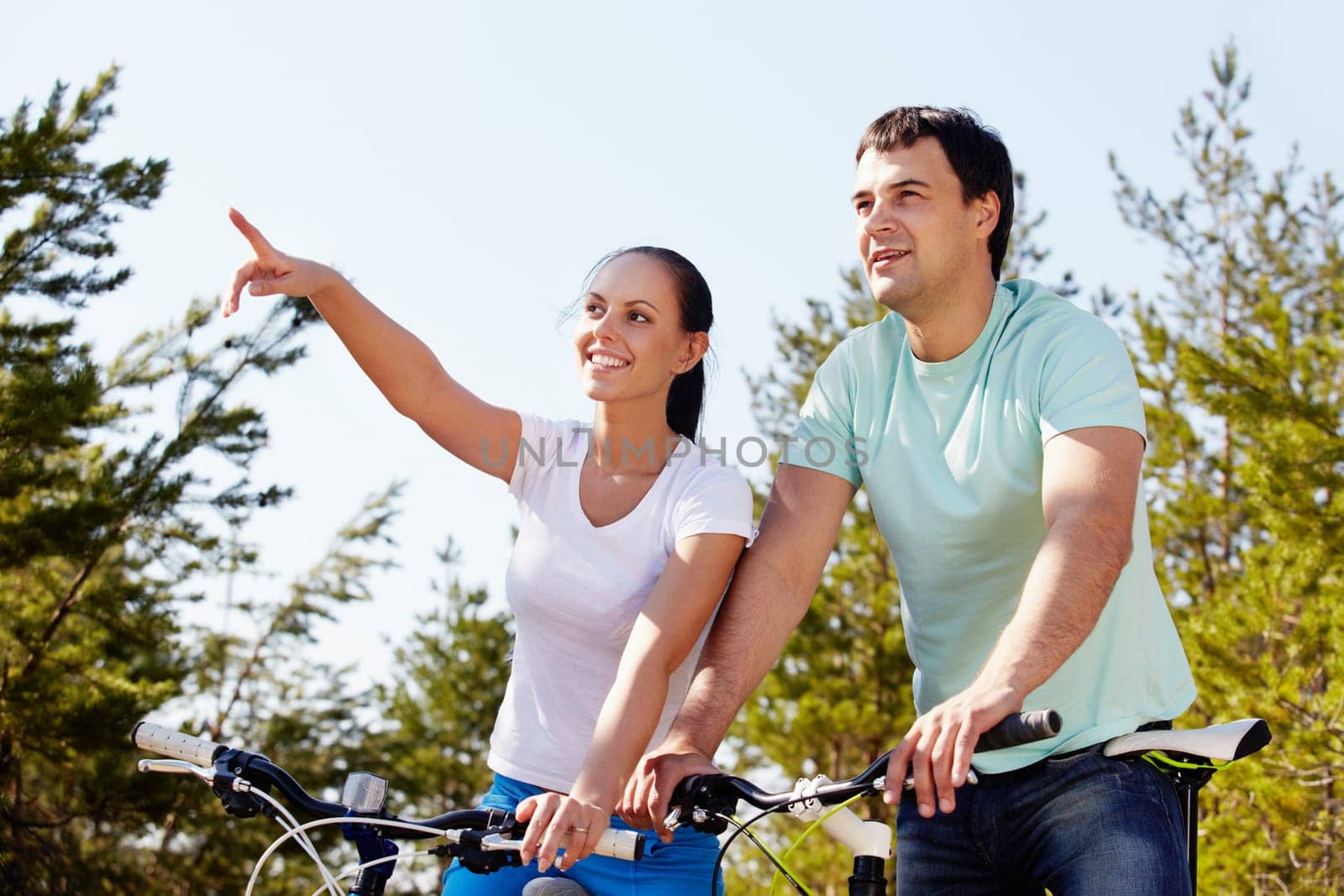 Portrait of a couple on bicycles looking into the distance