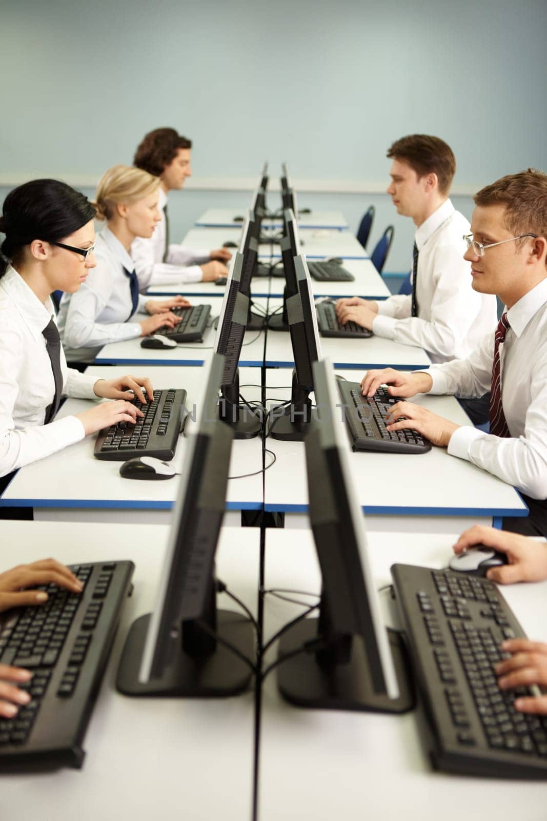 Image of businesspeople typing on the keyboards in line