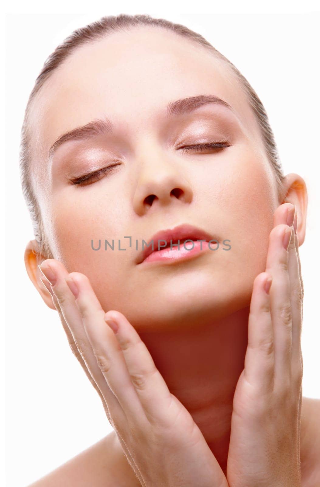Close-up of pretty young woman touching her face