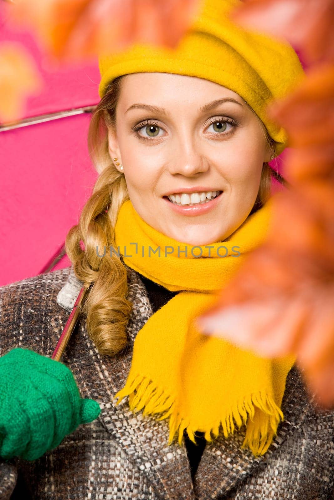 Happy woman in coat and beret looking at camera