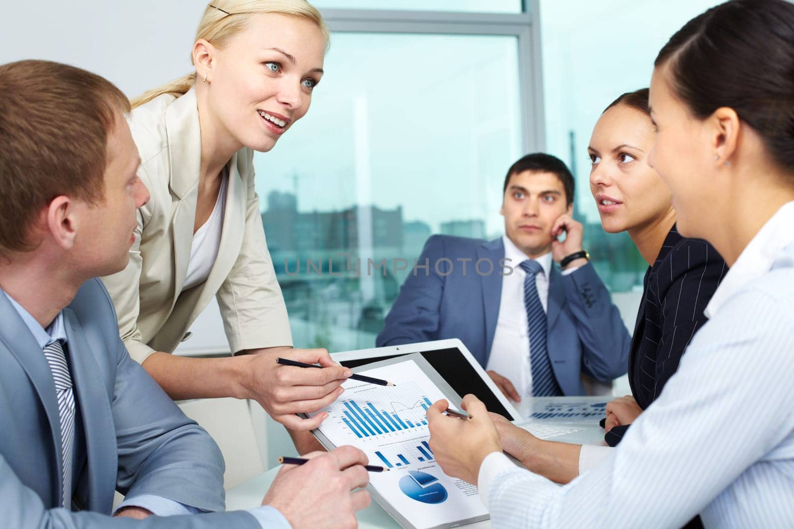 Businesswoman explaining business plan to her colleagues