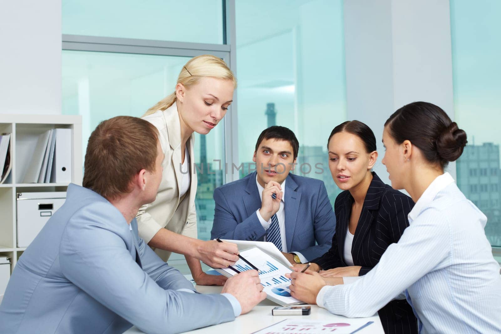 Business people looking at paper with charts