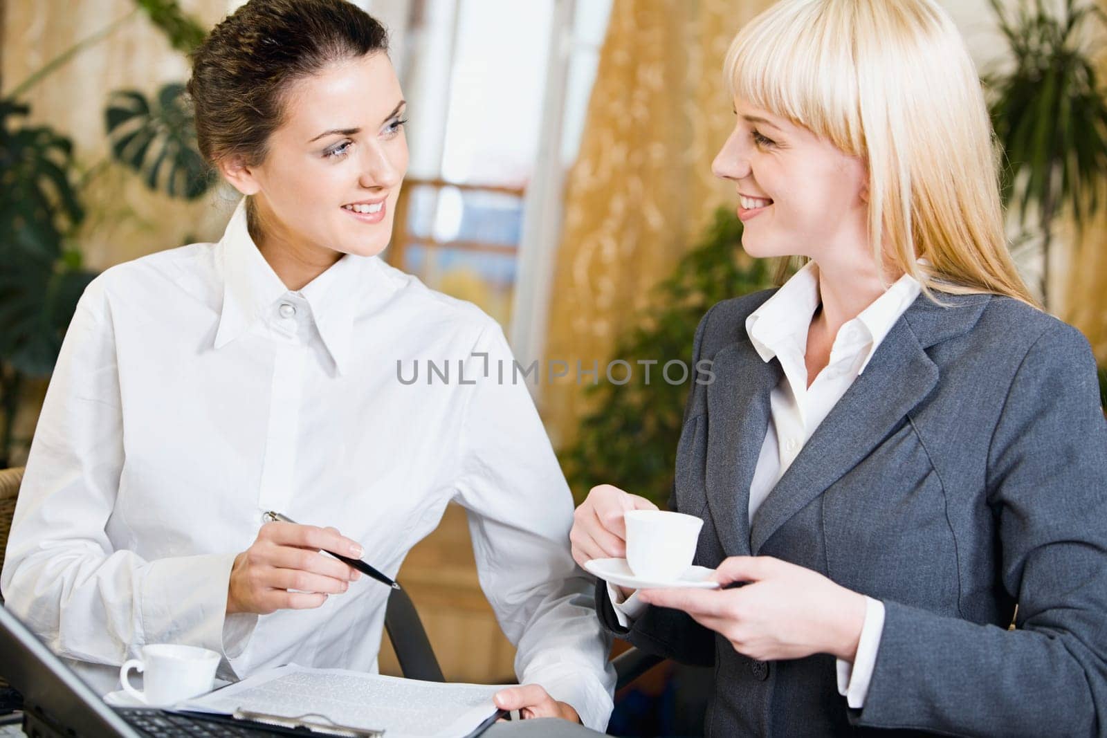Portrait of  two contemporary businesspeople at a meeting in a cafe