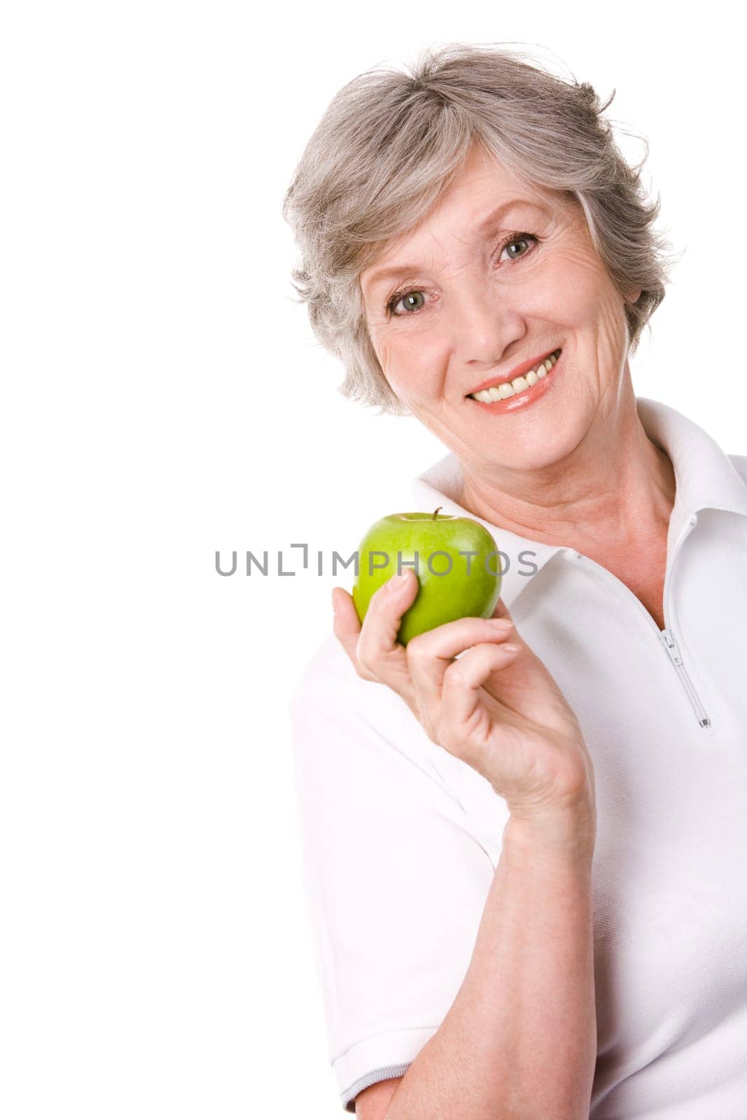 Portrait of aged female holding an apple and smiling