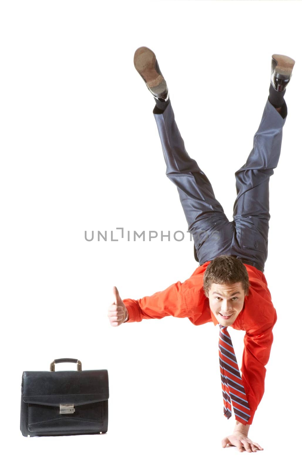 Image of businessman keeping himself on one arm while showing thumb up by another hand
