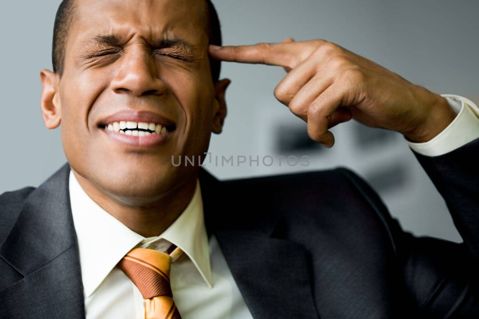 Image of confused man touching his temple with forefinger in trouble