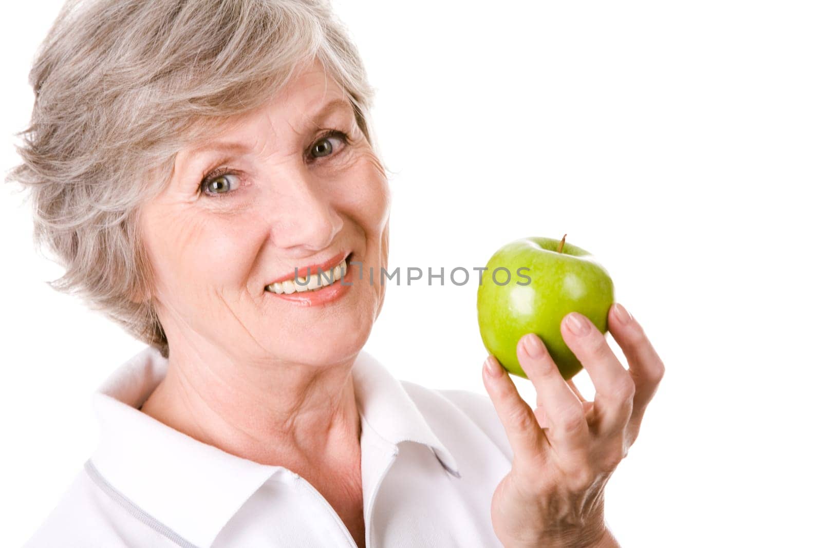 Portrait of mature woman smiling with green apple in hand