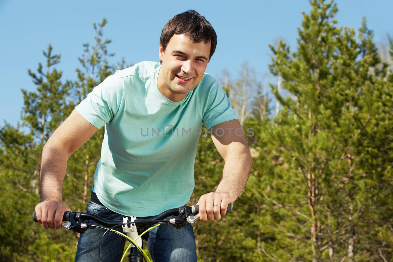 Portrait of a handsome man riding a bike