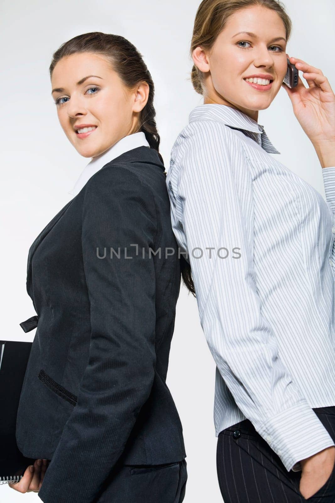 Portrait of two partners standing with their backs to each other