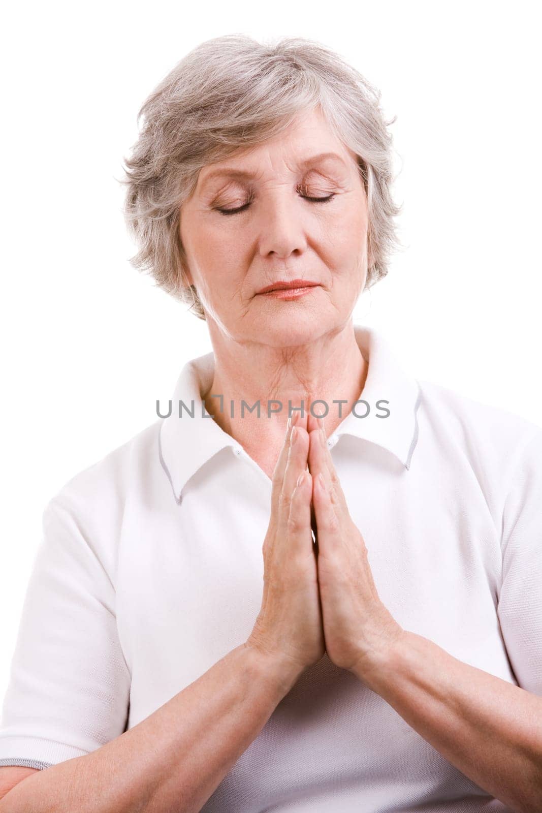 Portrait of mature woman praying with her hands put together and eyes shut