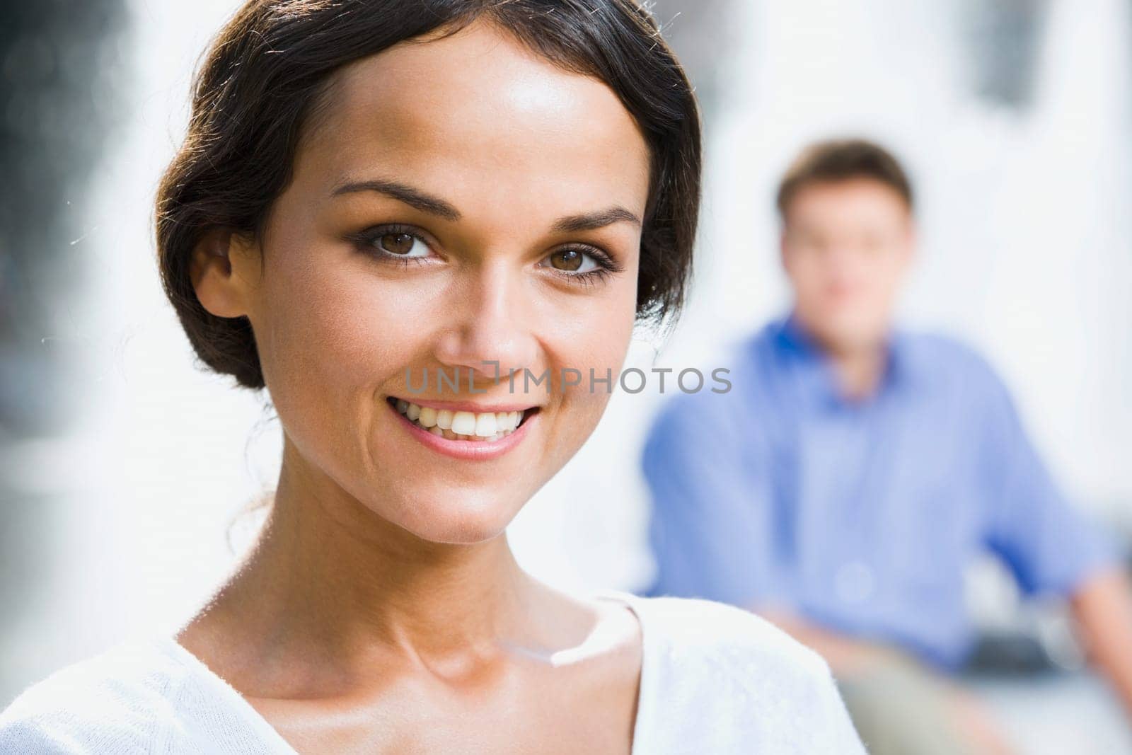 Portrait of pretty young woman with charming smile in the park