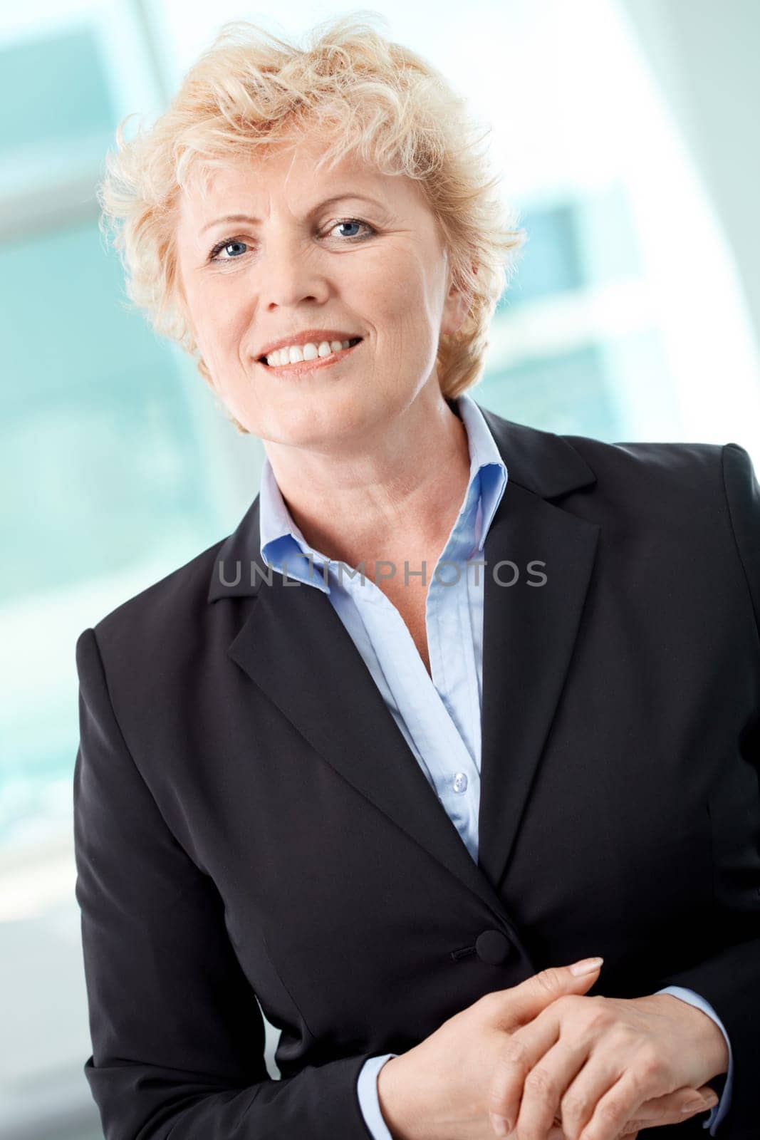 Portrait of smiling middle aged businesswoman looking at camera
