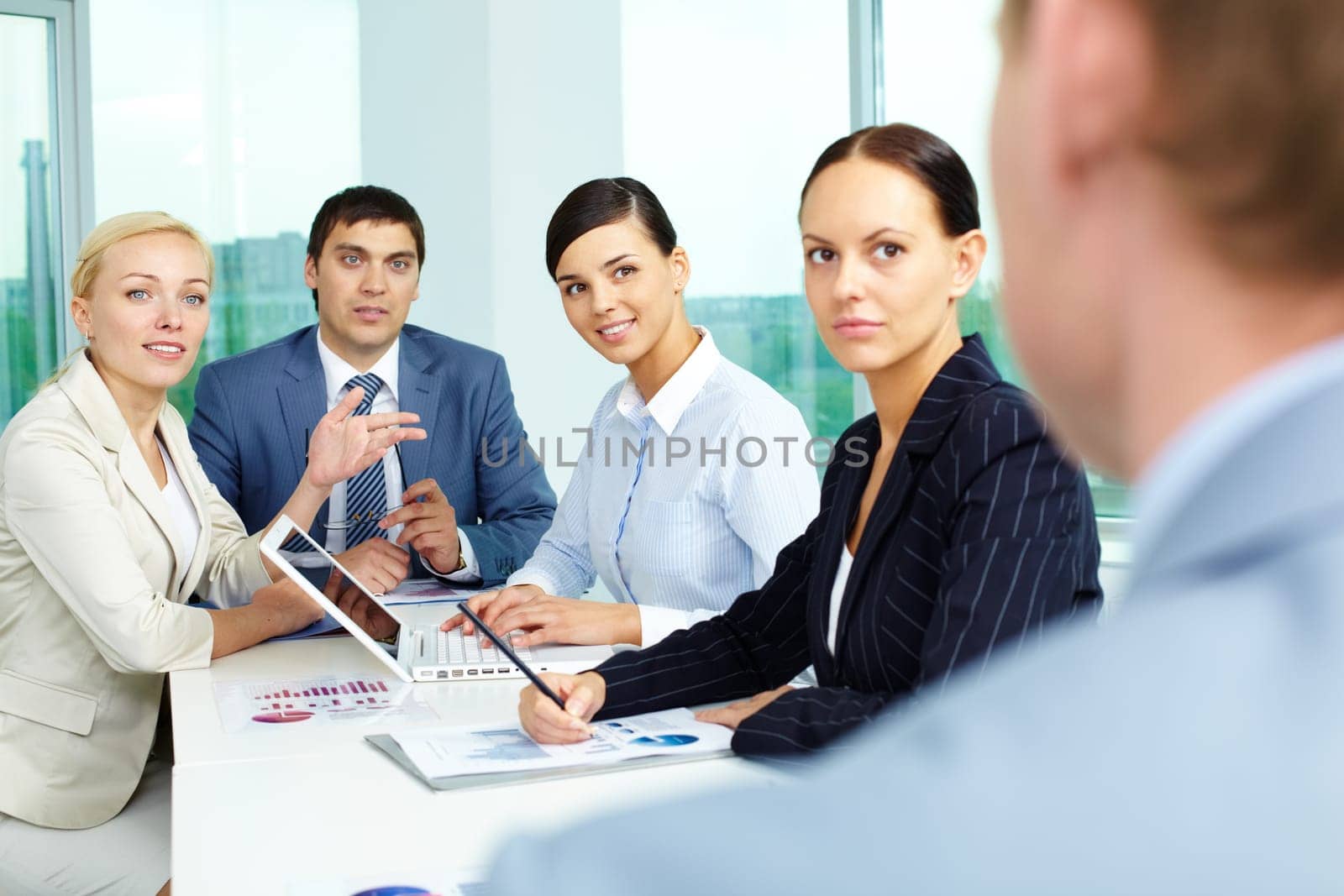 Group of business people looking at their employer while consulting in office