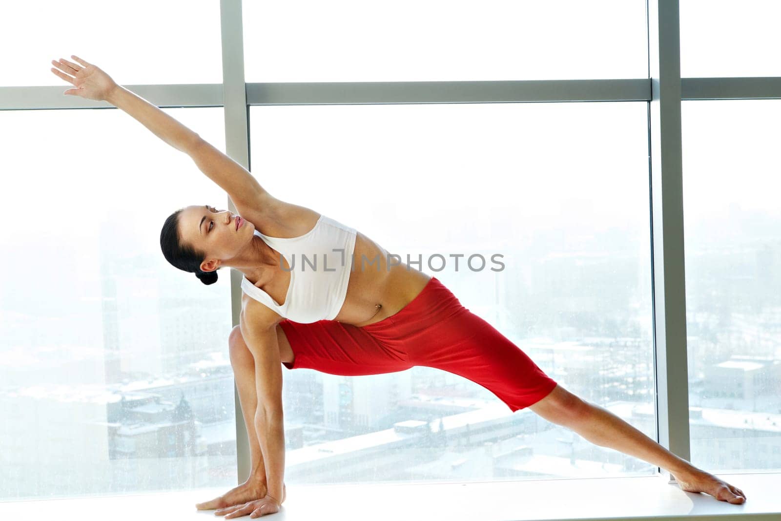 Portrait of young sporty girl doing physical exercise