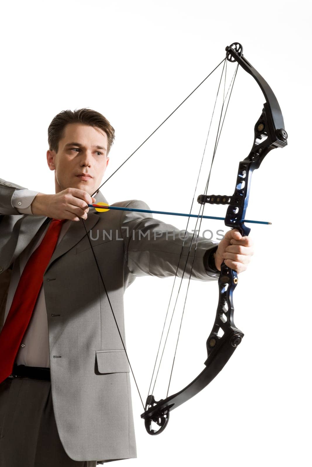 Portrait of businessman with crossbow isolated over white background