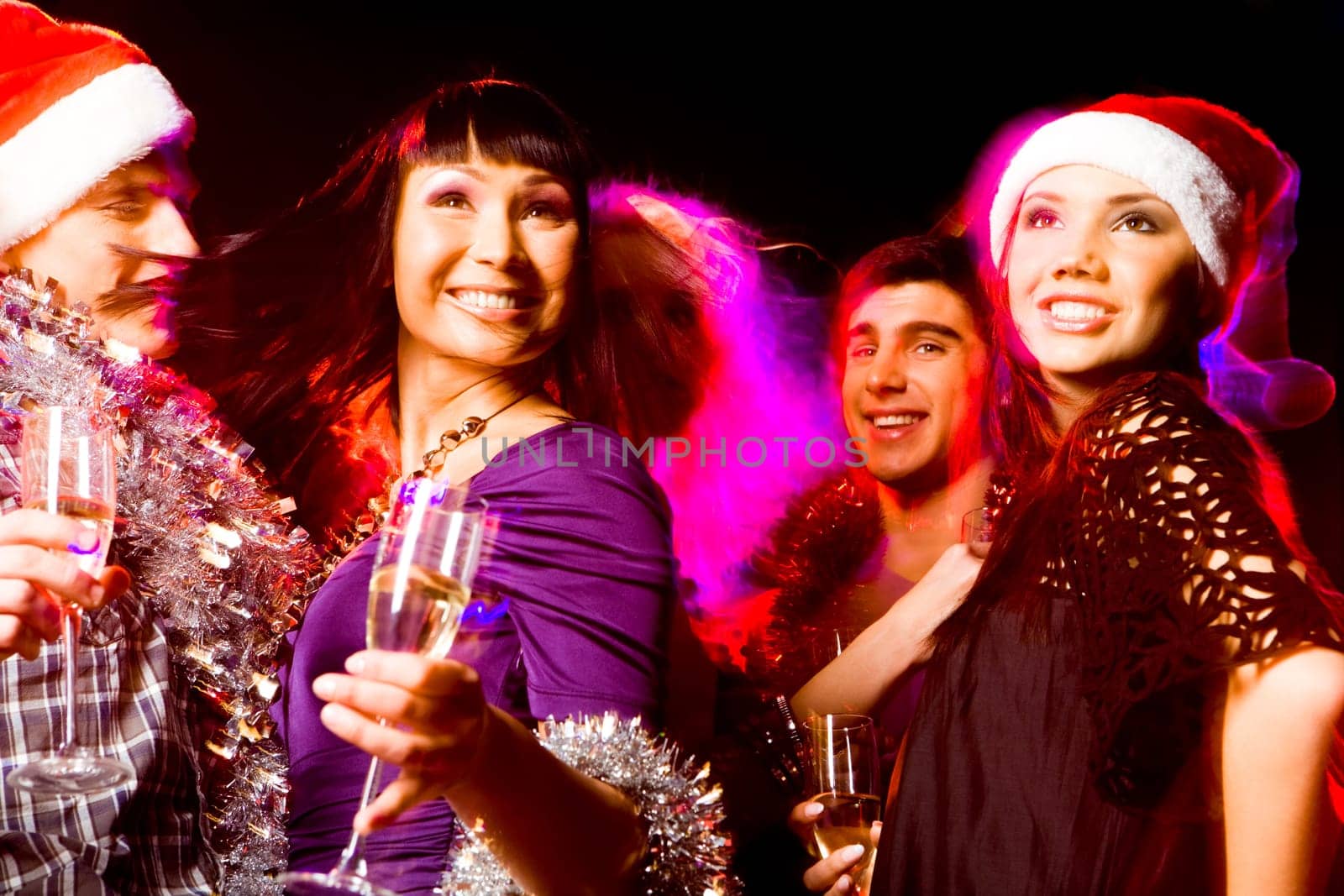 Image of joyful friends having fun at disco in night club at party