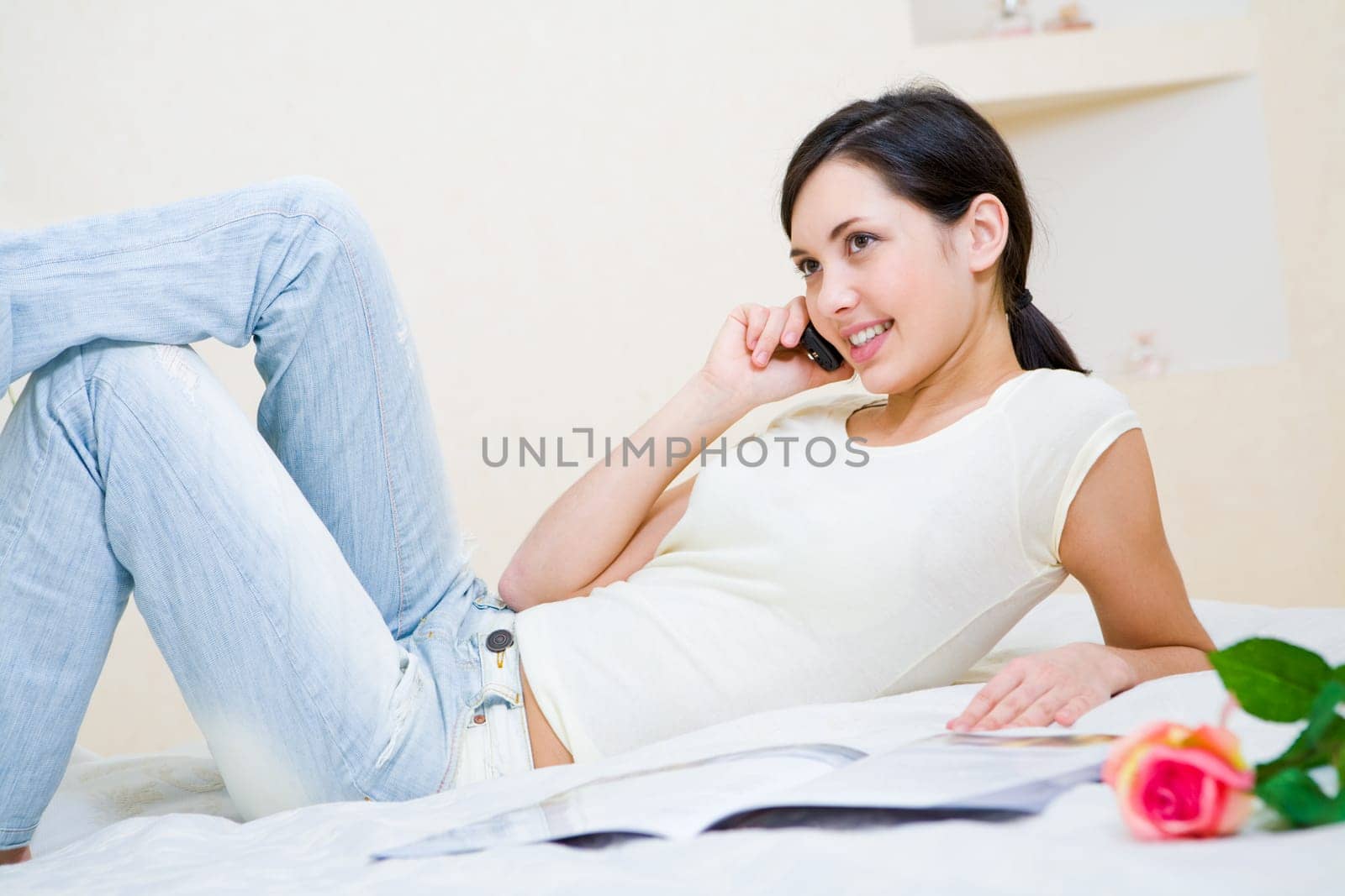 Image of pretty teenager speaking by the phone in a good mood