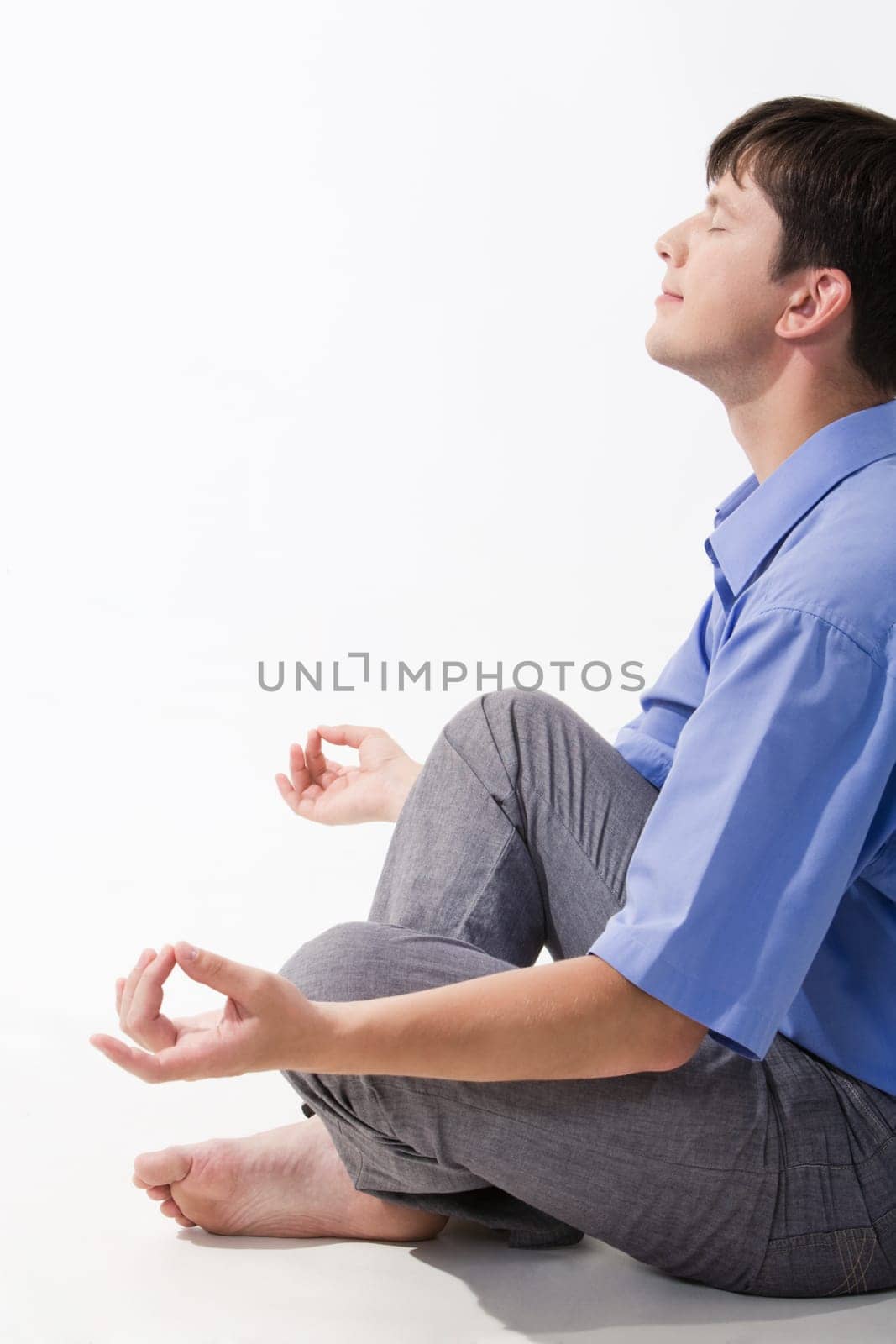 View of man doing yoga exercise and taking pleasure in it
