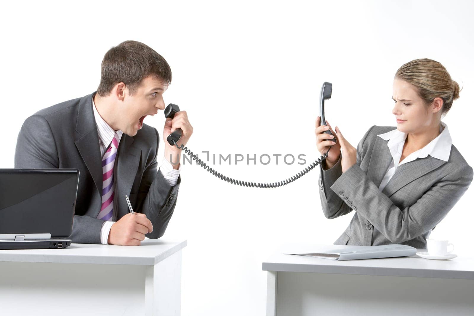 Portrait of angry boss shouting into telephone receiver at his secretary