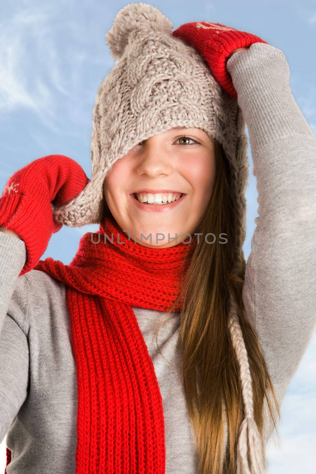 Portrait of cheerful teenage girl wearing warm knitted clothes