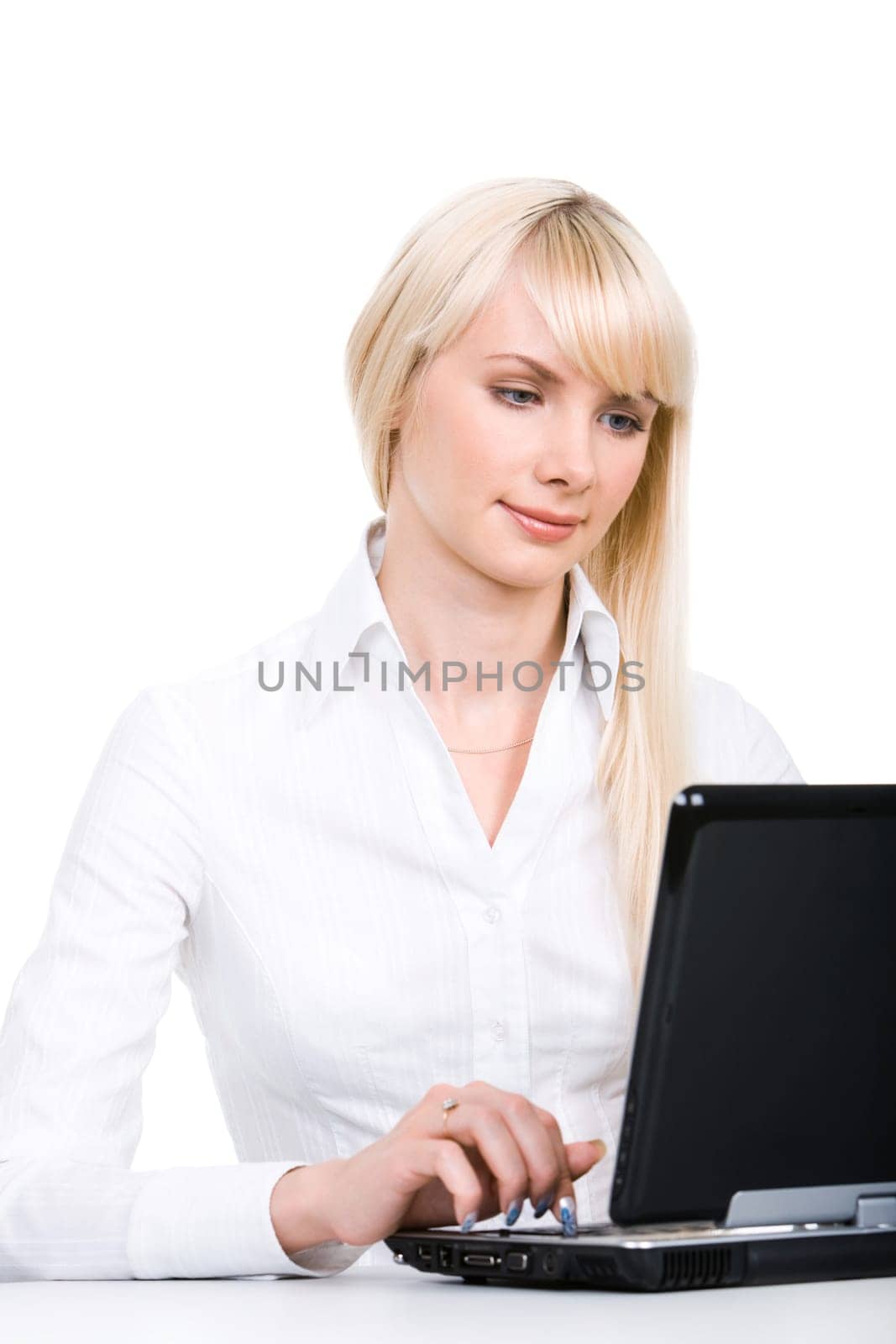 Portrait of blond woman sitting by laptop and working