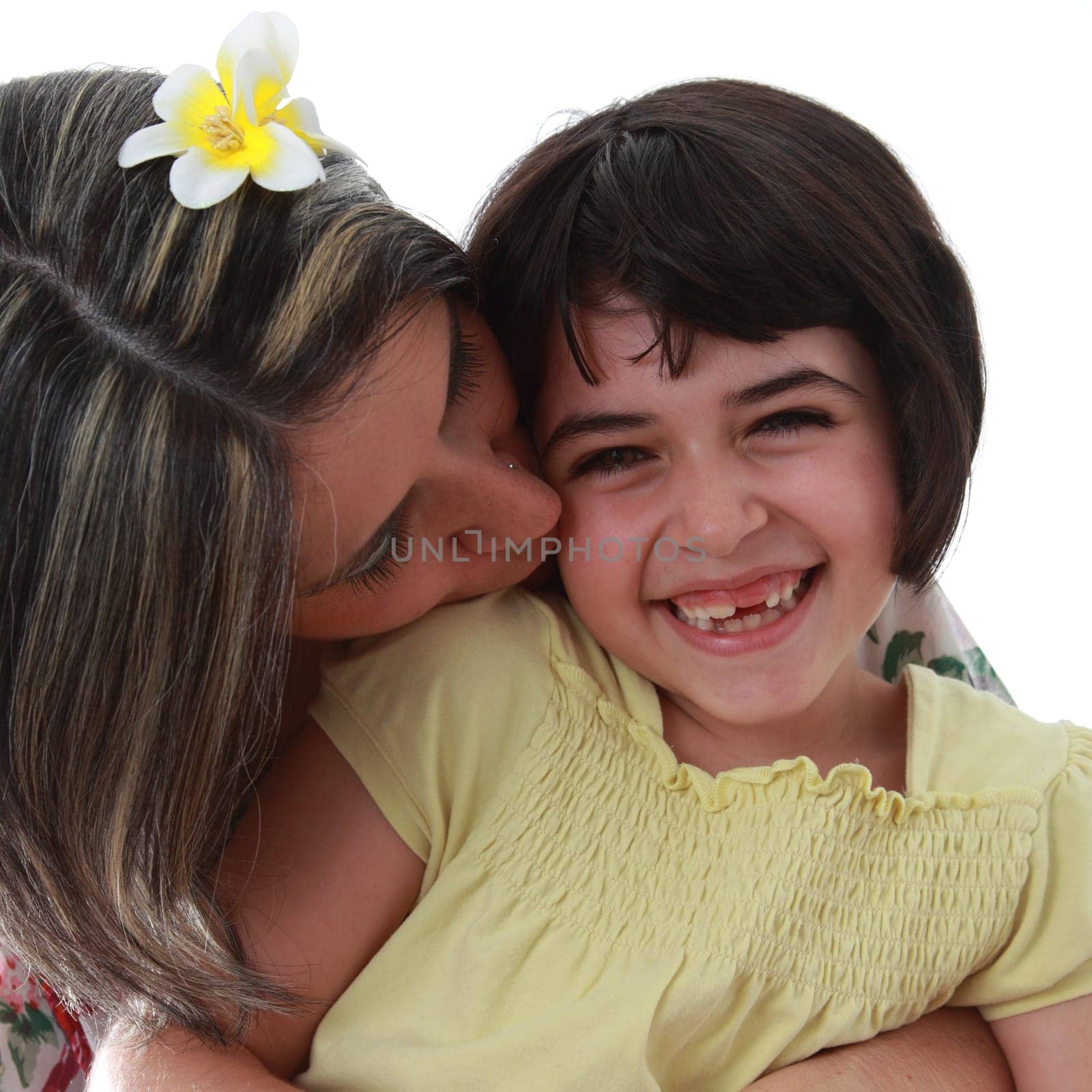 Details of a happy girl with her mother, isolated on white background. His mom wants her a little kiss