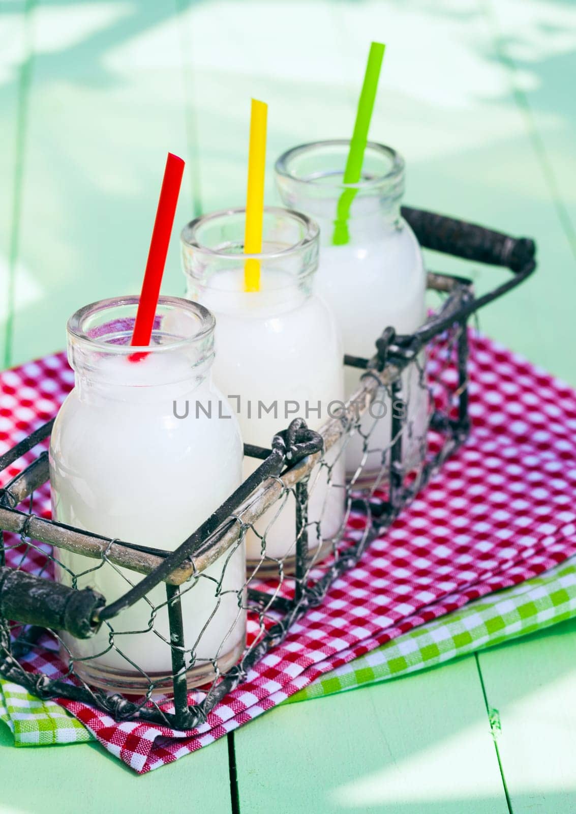 Different Milk Bottles in a tray on wooden board