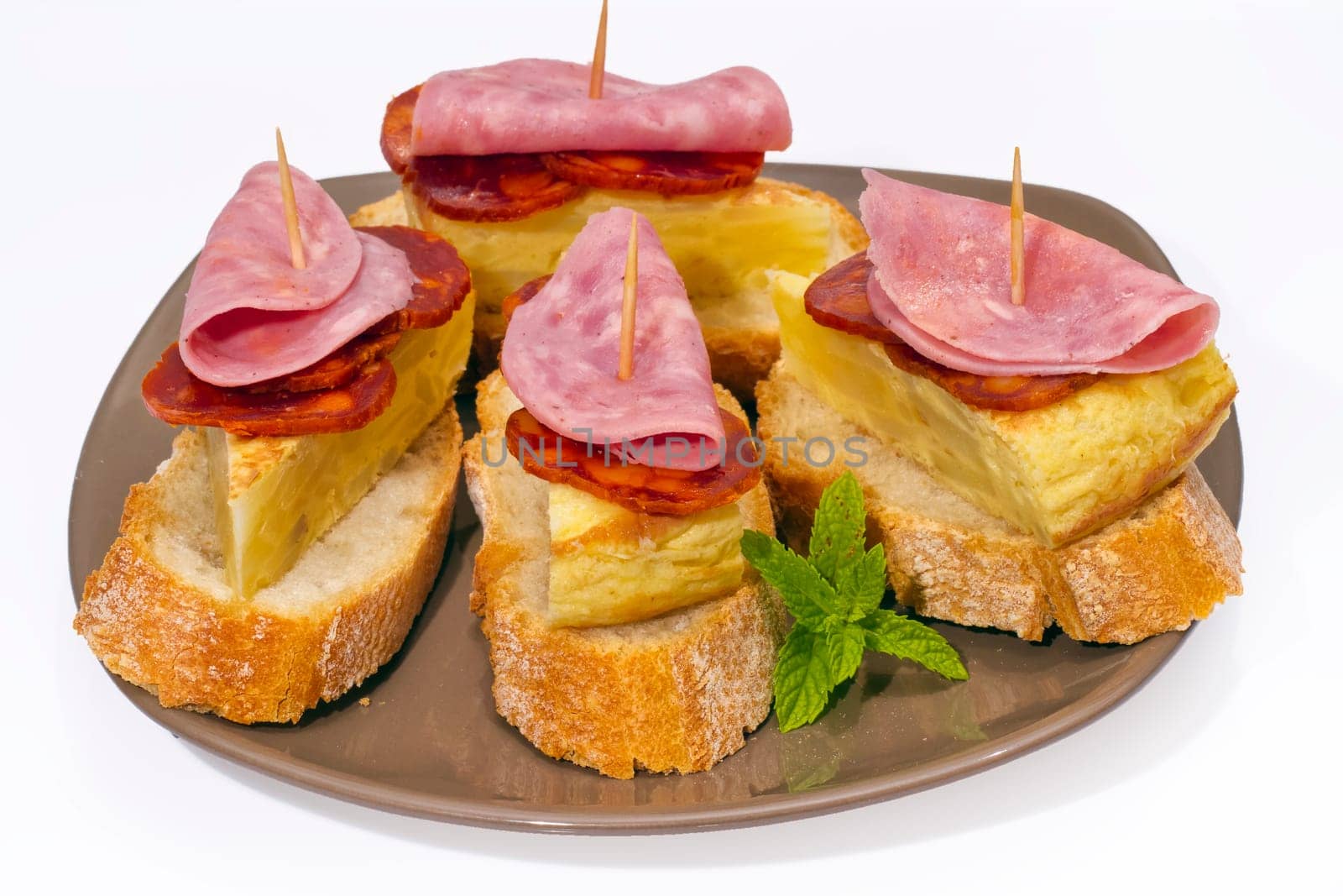Spanish omelette with chorizo Iberico, typical cover montadito