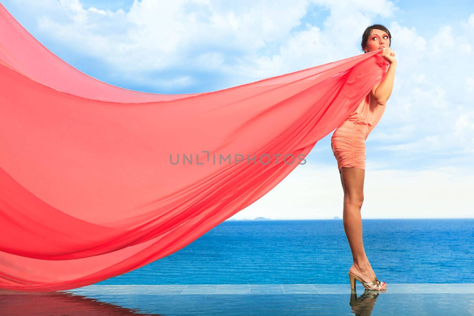 Woman with red scarf on water