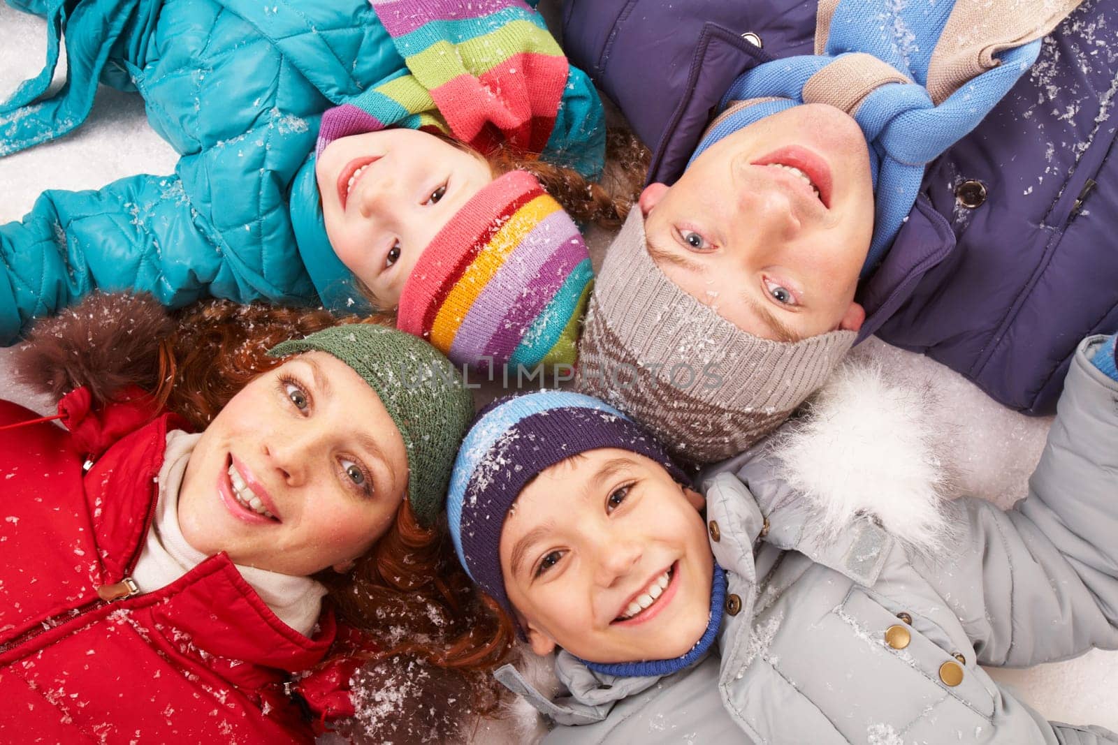 Above angle of happy family looking at camera