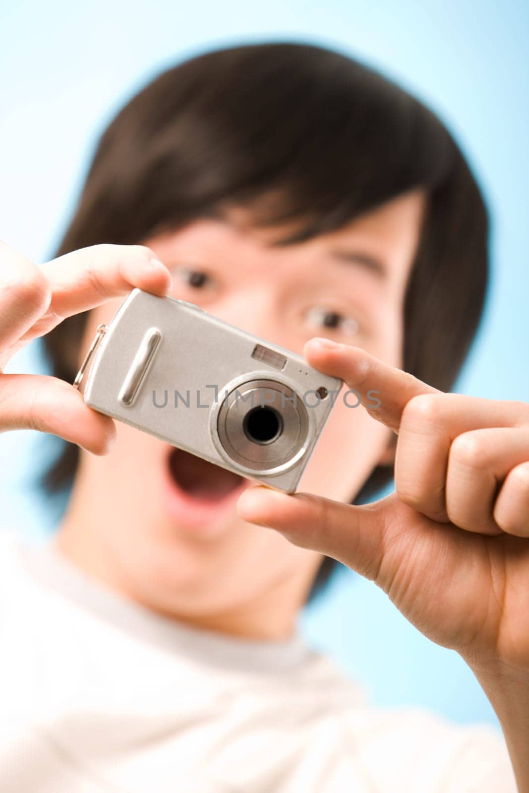 Image of photo camera in surprised guy hands after making a shot