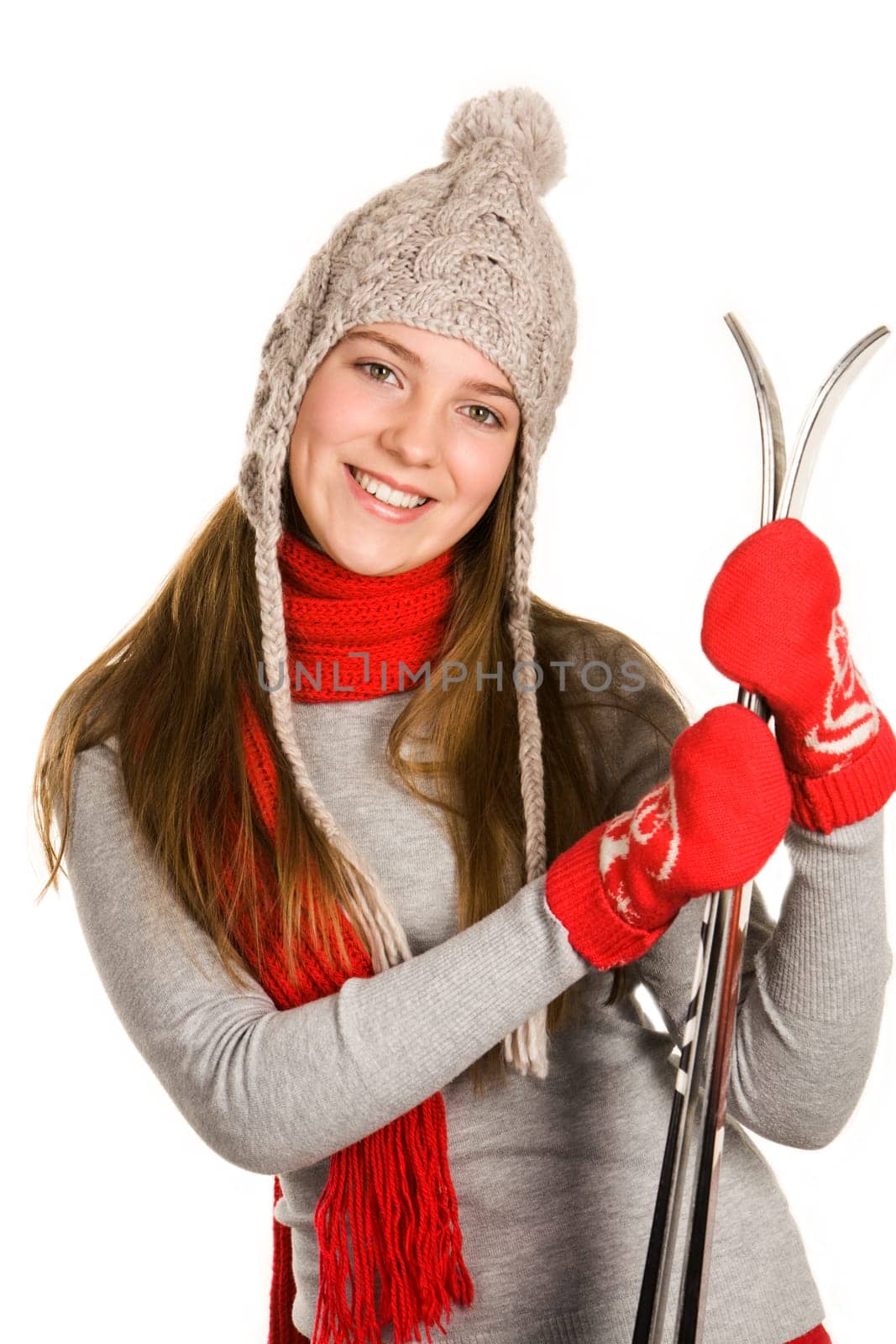 Portrait of positive sporty woman with skis looking at camera and smiling