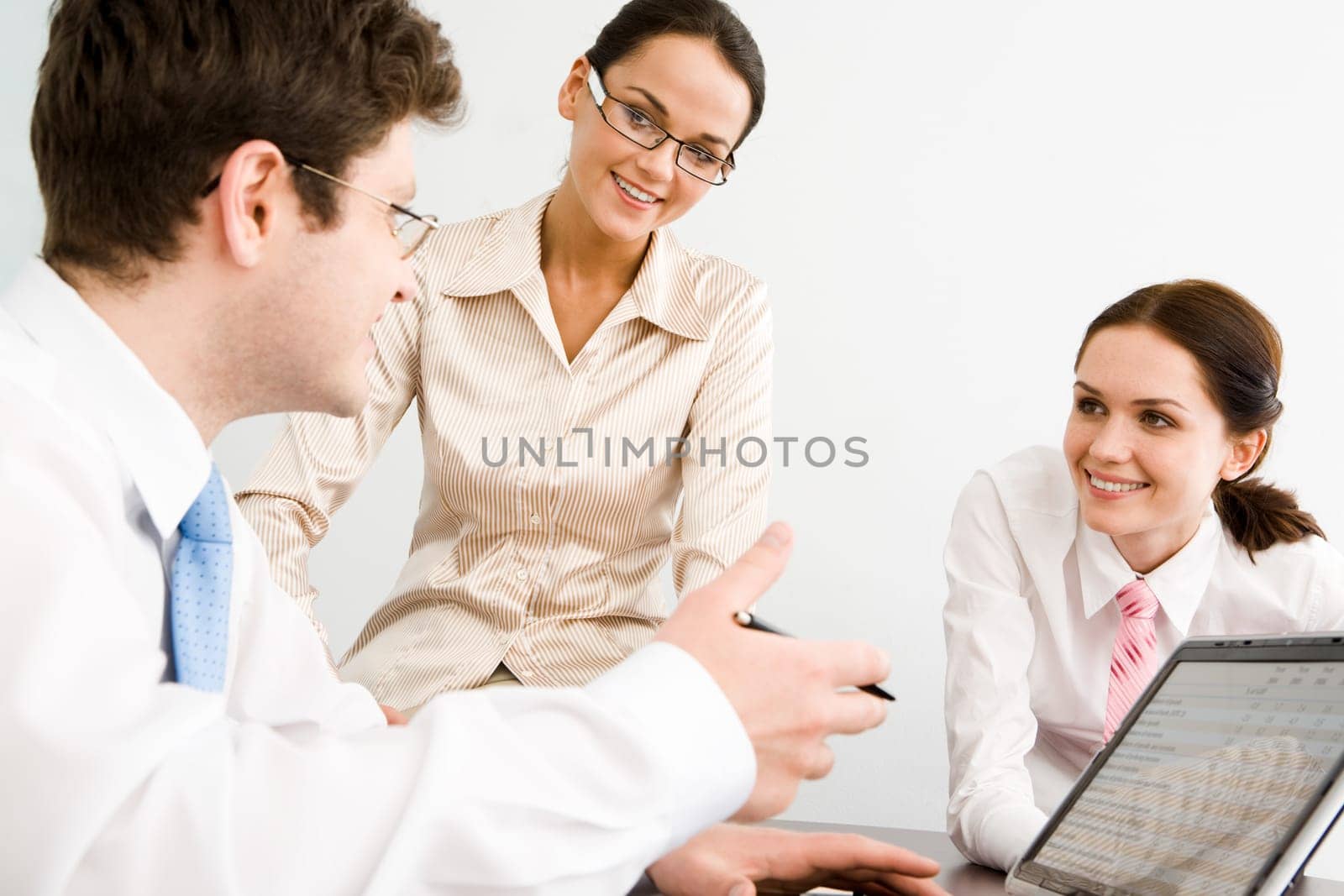 Business-team of three smiling people discussing new working ideas