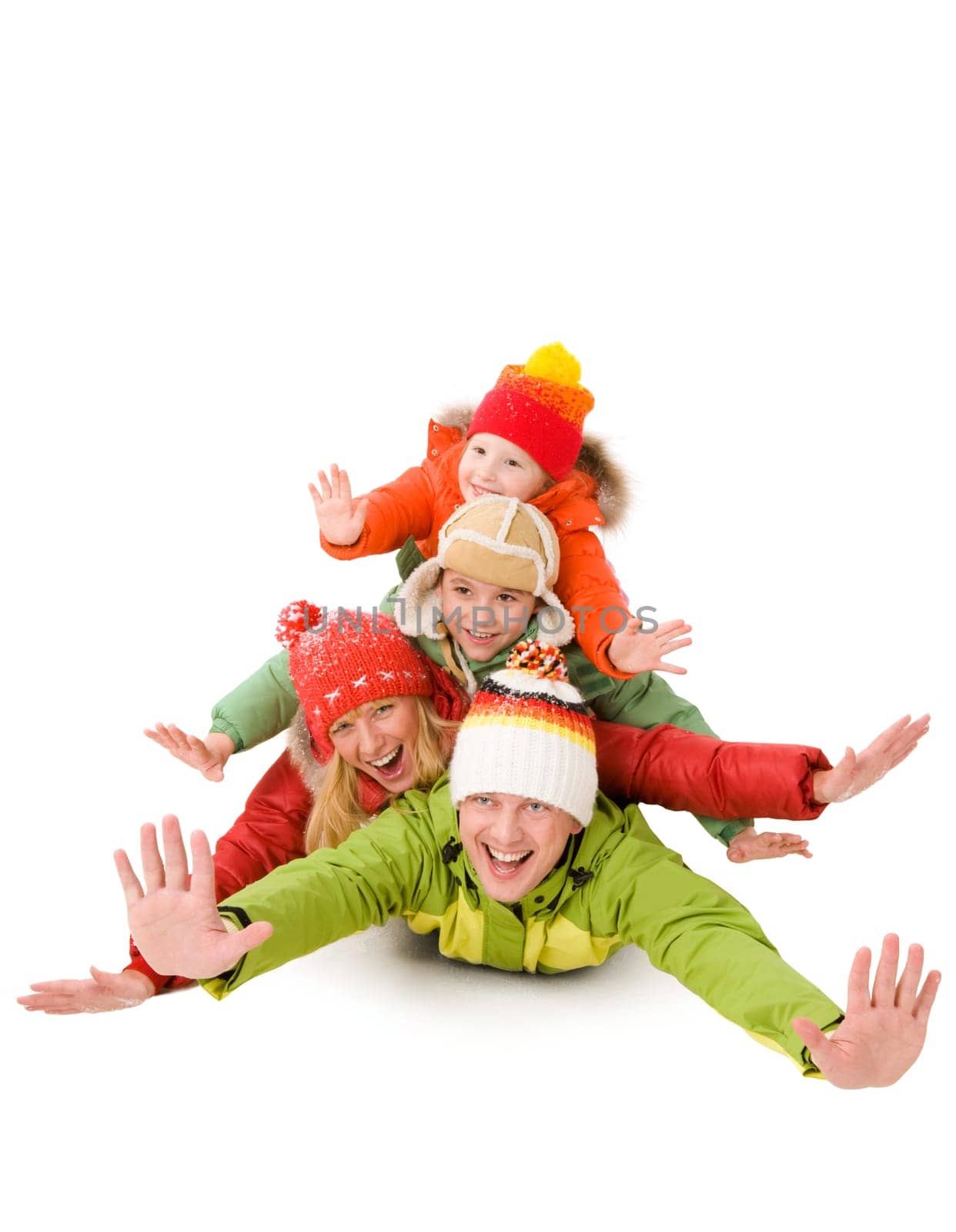 Happy family members laughing while lying with their arms stretched