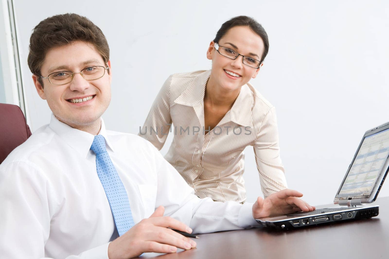 Photo of smiling boss looking at camera with woman on background