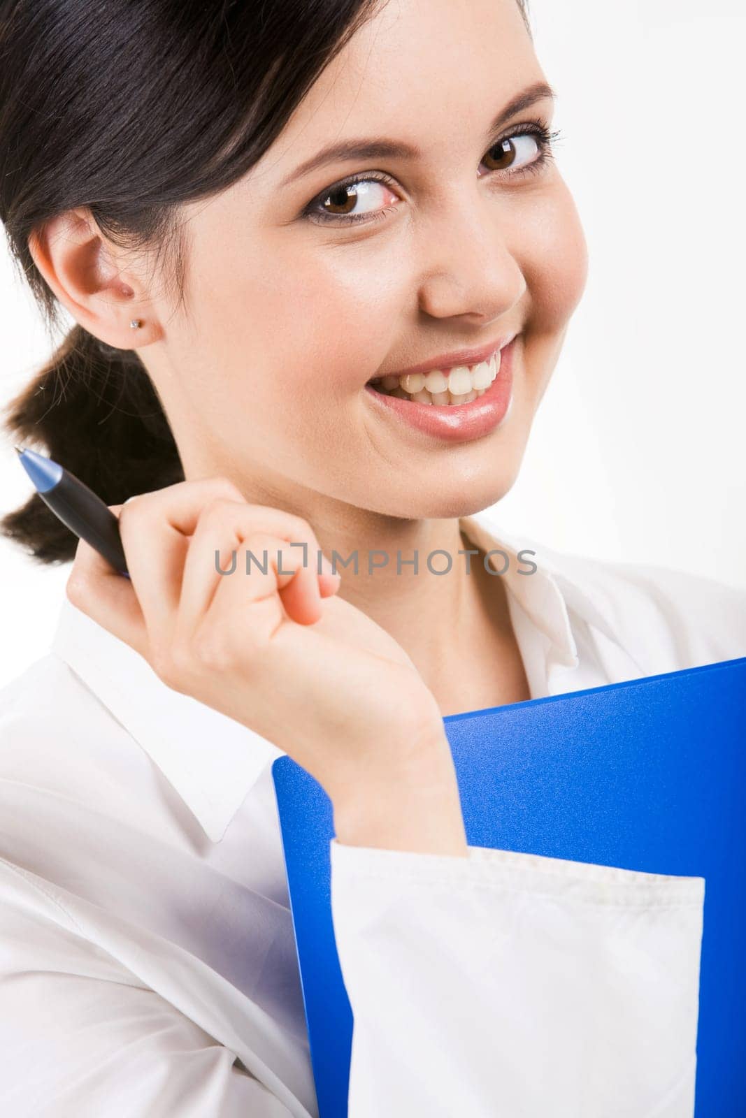 Close-up of happy girl with pen in hand smiling against white background