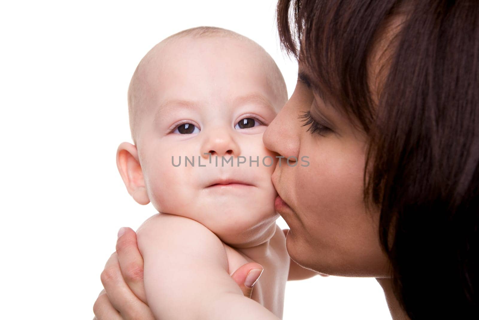 Close-up of careful mummy kissing her baby son on white background