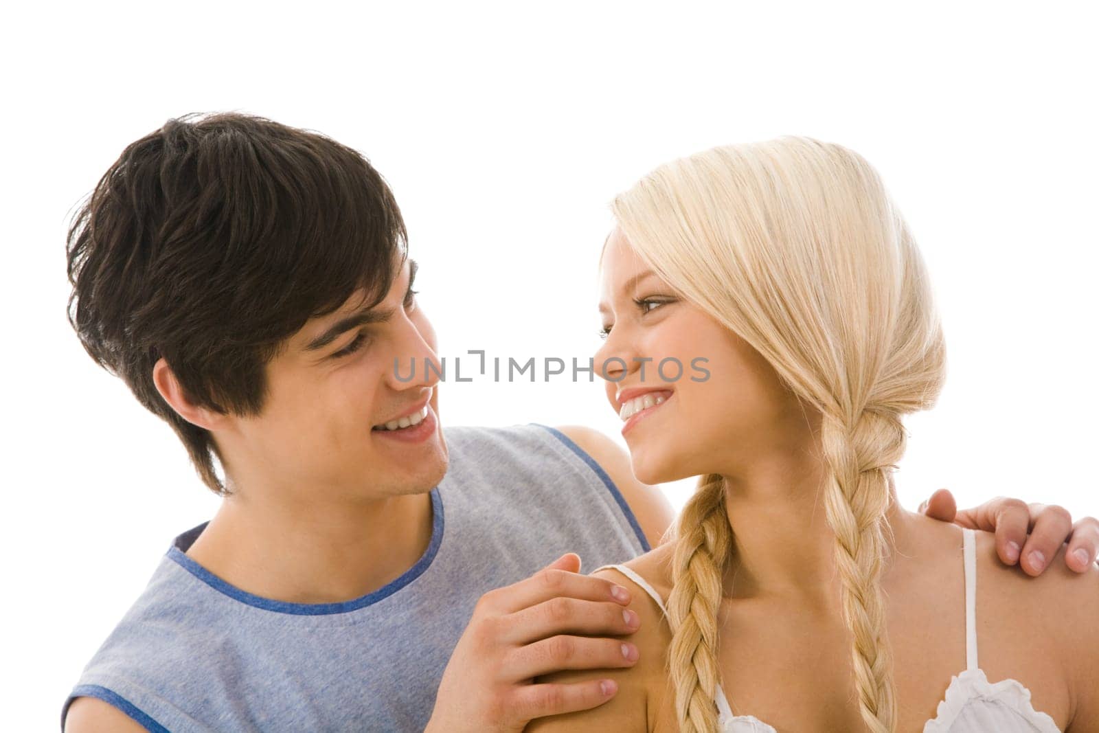 Image of beautiful blonde looking at handsome man while he embracing her